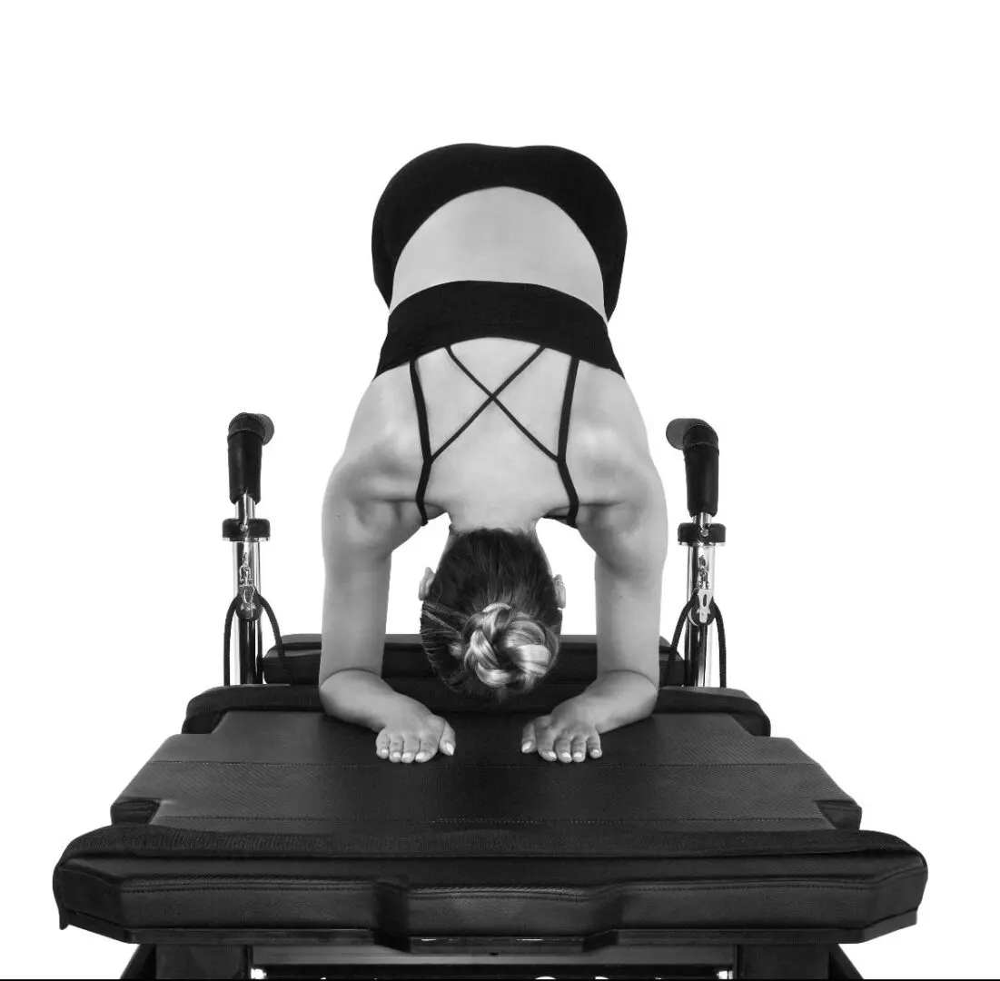 A person doing a handstand on top of a table.